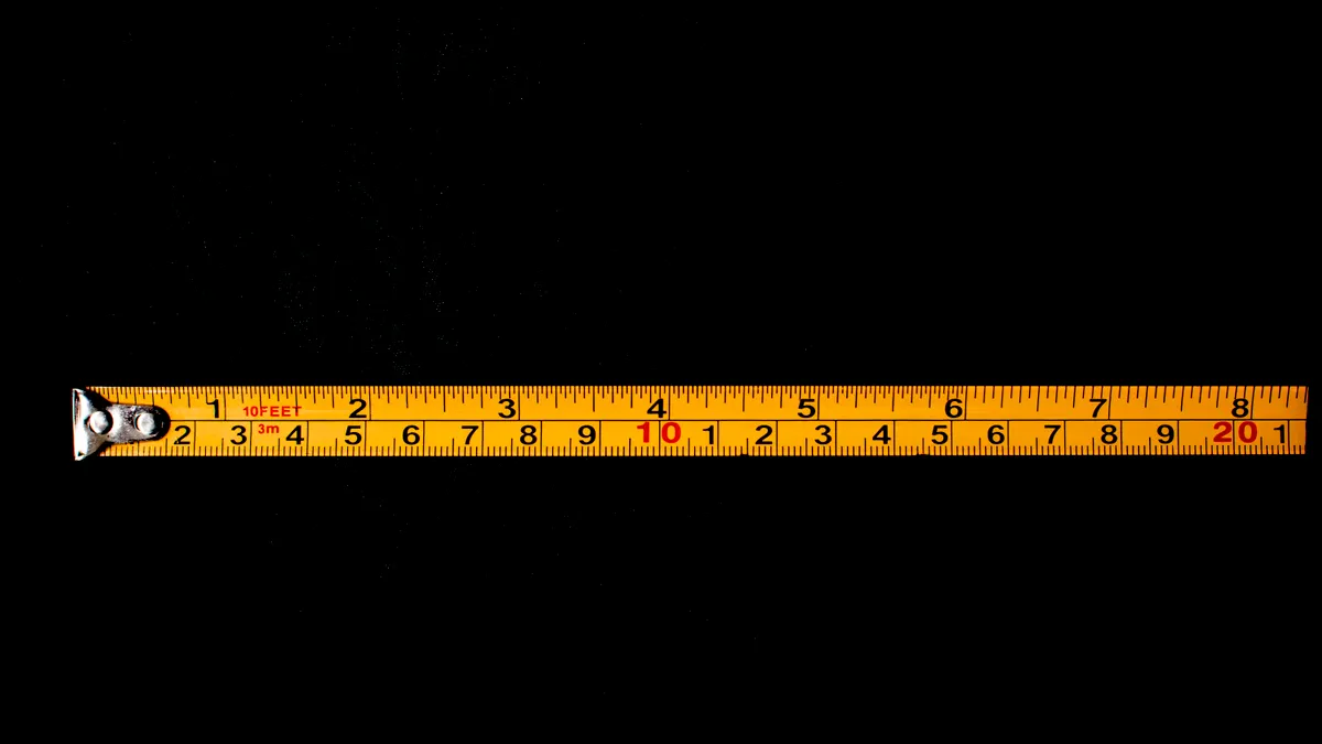 How Far Should a Septic System Be From a House, Well, or Property Line? Yellow tape measure stretched across a black background