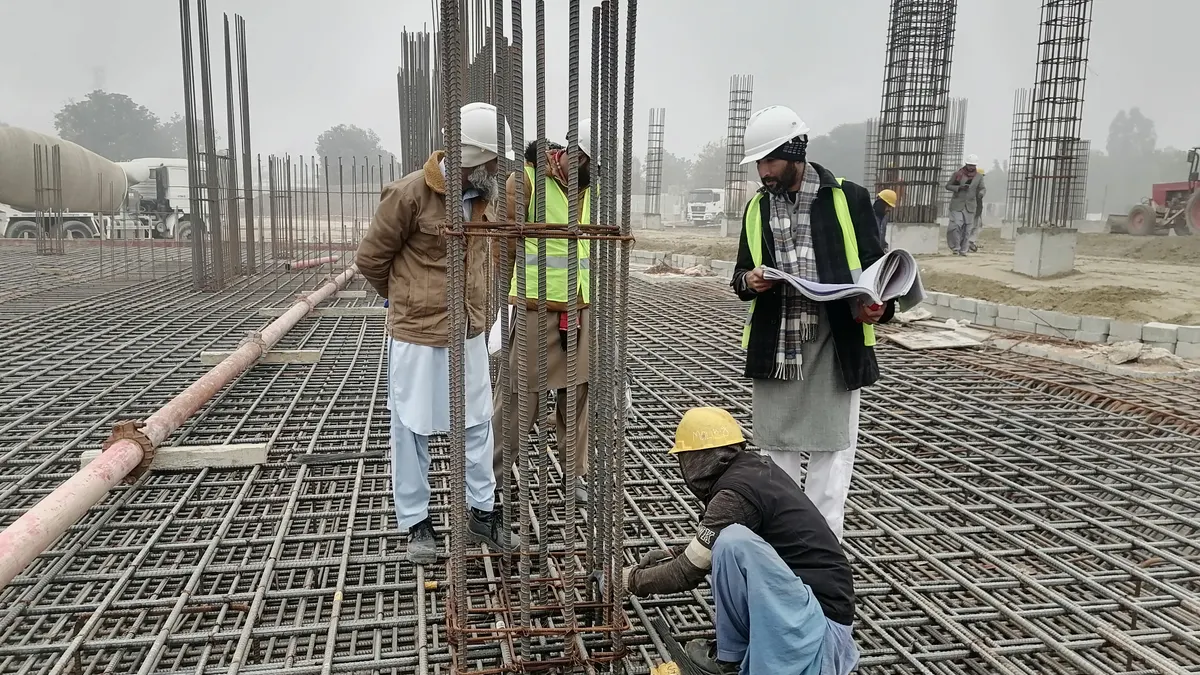 Septic installation and construction — The Complete Guide Workers inspecting rebar for a foundation pour