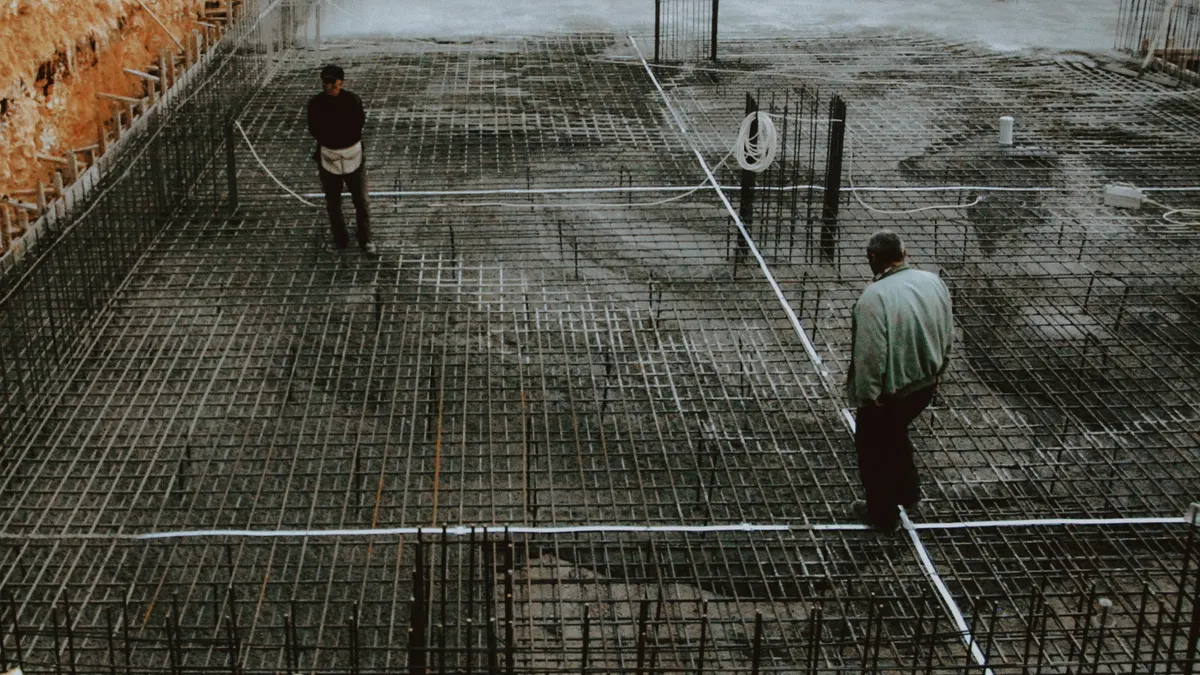 Septic installation and construction — The Complete Guide Workers over steel rebar in a foundation excavation